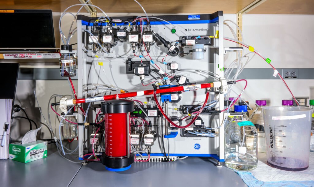 a machine on a workbench with tubes and jars